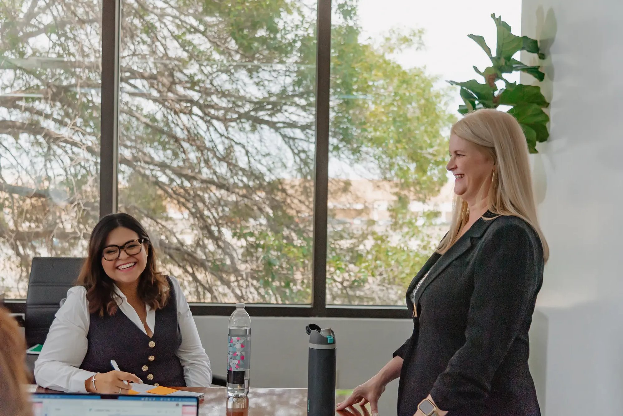 FUNDVIEW colleagues collaborating near a window.